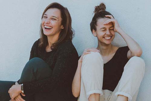 Shows two women laughing
